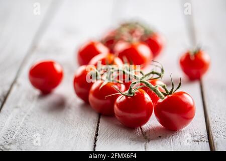Freshly grown tomartoes in the garden with lovely red colour full of summer sun rays. Stock Photo