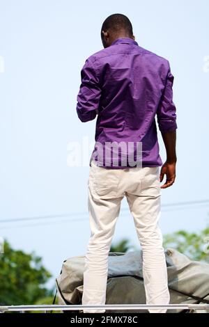 Back of a young black man with a purple shirt Stock Photo