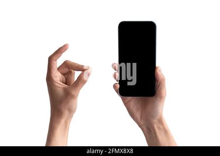 Pov of female holding smartphone with blank screen, showing ok Stock Photo