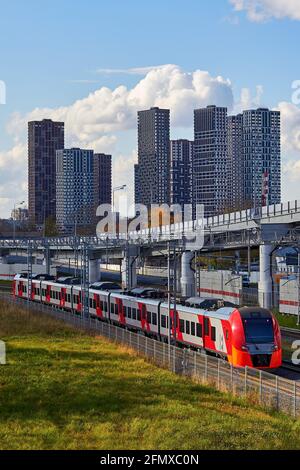 Railways train on the background of a modern city and blue sky Stock Photo