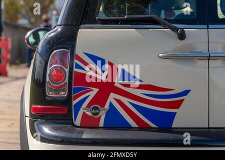 Rear door of a Mini Cooper car with an Union Jack flag painted on the door. Stock Photo