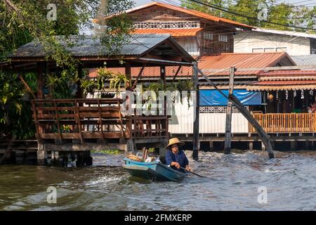 Thai lady in rowing boat on Khlong Chak Phra, Bangkok, Thailand Stock Photo