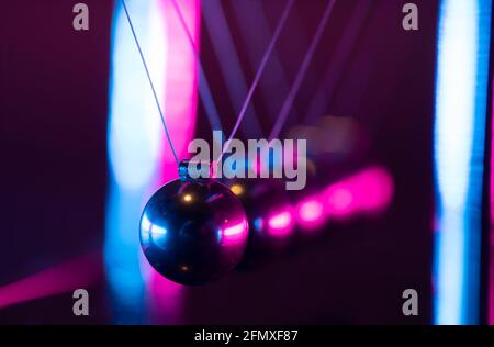 Newton cradle. Demonstrating gravity, action and reaction principle in physics. Stock Photo