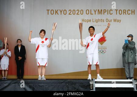 (210512) -- FUKUOKA, May 12, 2021 (Xinhua) -- Takeshita Yoshie (L) and Fukui Tsuyoshi are seen during the ignition ceremony for the Tokyo Olympic torch relay at Heiwadai Athletic Stadium in Fukuoka, southwestern Japan, May 12, 2021. The torch relay was taken off public roads and replaced by ignition ceremony due to the coronavirus pandemic. (Tokyo2020/Handout via Xinhua) Stock Photo