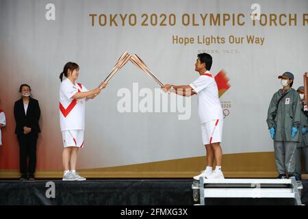 (210512) -- FUKUOKA, May 12, 2021 (Xinhua) -- Takeshita Yoshie (L) and Fukui Tsuyoshi are seen during the ignition ceremony for the Tokyo Olympic torch relay at Heiwadai Athletic Stadium in Fukuoka, southwestern Japan, May 12, 2021. The torch relay was taken off public roads and replaced by ignition ceremony due to the coronavirus pandemic. (Tokyo2020/Handout via Xinhua) Stock Photo