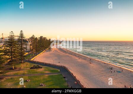 Adelaide, South Australia - January 12, 2019: Glenelg Beach aerial view with people walking along at sunset on summer evening Stock Photo