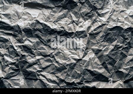 crumpled paper background. gray ashy matte color, shadows, planet surface, mountain view from space. Stock Photo