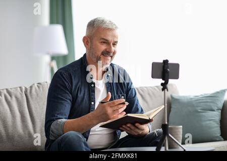 Happy elderly man studying online while staying home Stock Photo