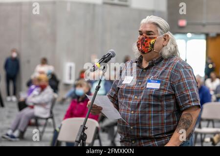 Jackson, Michigan, USA. 11th May, 2021. A man speaks as the Independent Citizens Redistricting Commission holds its first public hearing in advance of redrawing the maps for Michigan's Congressional and legislative districts. The Commission was established by the Voters Not Politicians ballot initiative, passed in 2018, which aimed to end gerrymandering by taking the redistricting power away from the legislature. Credit: Jim West/Alamy Live News Stock Photo