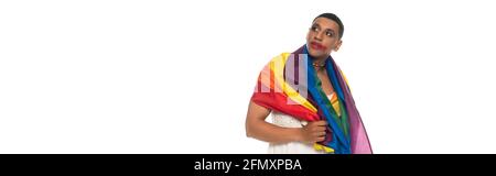 african american transsexual man, covered with lgbt flag, looking way isolated on white, banner Stock Photo