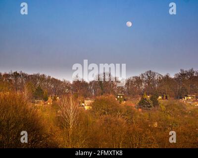 Moon in the blue sky over the hill Stock Photo