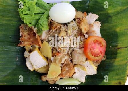 Gado-gado, Indonesian salad dish wrapped in banana leaf. Stock Photo