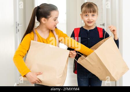 advertising, childhood, delivery, mail and people - two little girls with delivery packages Stock Photo