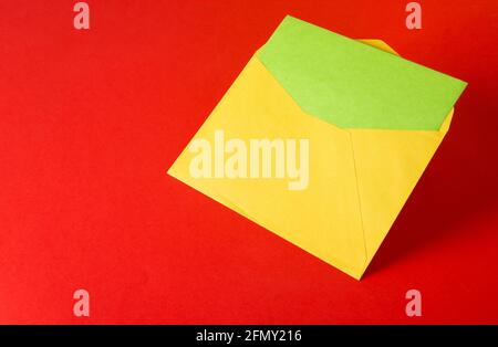 Colorful paper envelopes on red background - top view Stock Photo