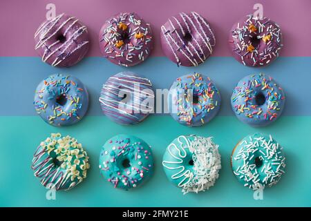Colorful Donuts on striped pastel background Stock Photo