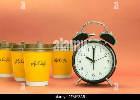 Morning red alarm clock and disposable paper cup or mug isolated on white with clipping path Stock Photo
