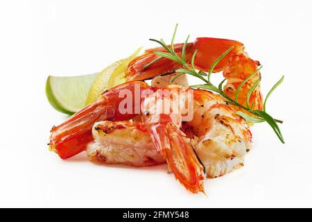 Grilled prawn tails with lemon, lime, rosemary on white Stock Photo