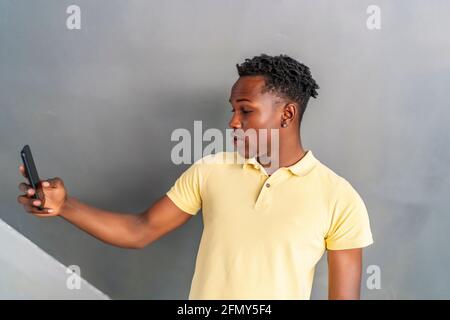 young african man surprised with his smartphone Stock Photo