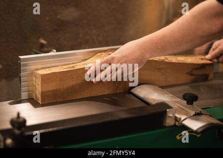 Carpenter working with wood in the workshop, hands close-up Stock Photo
