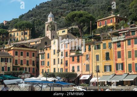 Bright-coloured facades in between the water and the hills form the small town of Portofino. Stock Photo