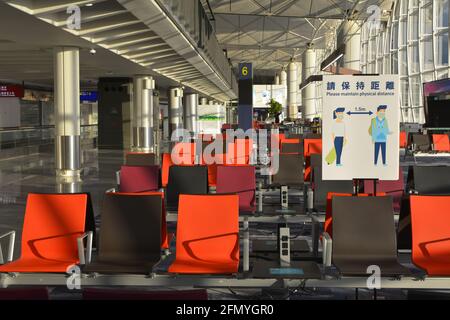 Covid physical distancing sign in an empty Chek Lap kok, Hong Kong international airport. Not many passengers flying with the current restrictions. Stock Photo