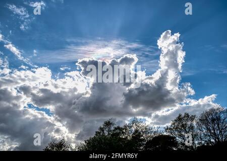 The sun behind dramatic cumulus clouds over Norfolk. Stock Photo