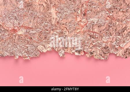 Gold leaf border, torn foil edges on pink, abstract background. Stock Photo