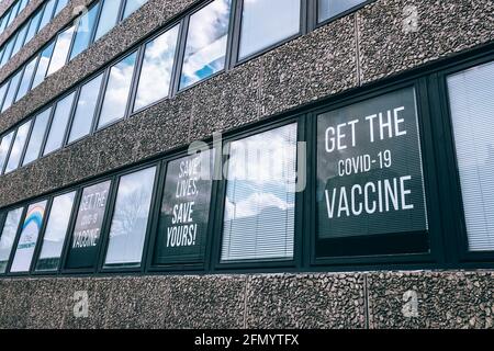 Get the Covid 19 vaccine sign in window Stock Photo