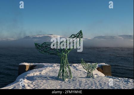 Teriberka, Murmansk region Russia - 01.19 2020: Whale metallic tail statue on the pictoresque village Stock Photo