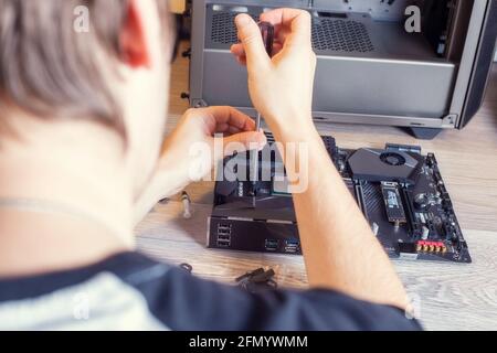 Installing a cooler on a personal computer processor. The process of upgrading computer maintenance in a service Stock Photo