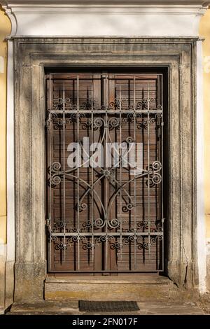 An old door locked behind a closed decorative lattice Stock Photo