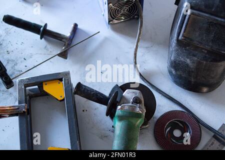 welding equipment, on the table, various hand tools are laid out around Stock Photo