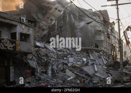 Gaza, Palestine. 12th May, 2021. View of the debris of Al-Sharouk tower that collapsed after being hit by an Israeli air strike. (Photo by Nidal Alwaheidi/SOPA Images/Sipa USA) Credit: Sipa USA/Alamy Live News Stock Photo