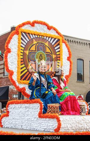 Tahlequah USA 8-31-2019 Native American Princesses in traditional costumes wave from ornate float in Cherokee National Homecoming parade Stock Photo