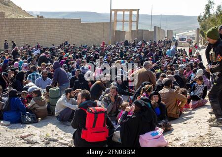 Mosul, Iraq. 7th Mar 2017 Civilians fleeing their homes near Tall ar Rayyan neighborhood in West Mosul wait as they are processed by soldiers. Stock Photo