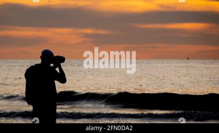 Silhouette of a man photographing at sunset in Den Haag or The Hague City in the Netherlands Stock Photo