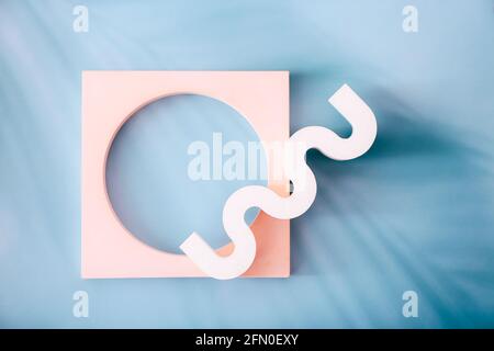 Exhibition podium with geometric shapes on a blue background with palm leaves shadows. Mockup Stock Photo
