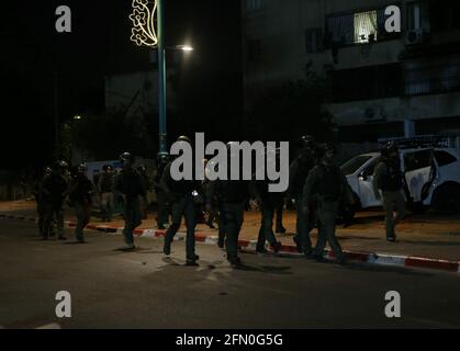 Lod, Israel. 12th May, 2021. Israeli security force members patrol in Lod, central Israel, on May 12, 2021. Israeli police announced on Wednesday that a night curfew will be imposed in Lod, where clashes between Arabs and Jews have been spiraling for days. Credit: Muammar Awad/Xinhua/Alamy Live News Stock Photo