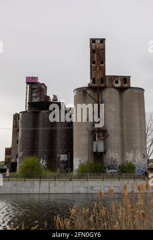 There is a strange pink cabin on top of an abandoned factory building located in front of the Canal Lachine in Montreal. Stock Photo