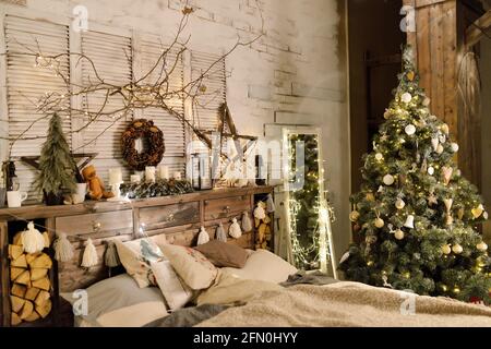 Cozy bed with Christmas pillows decorated with Christmas decor Stock Photo  - Alamy