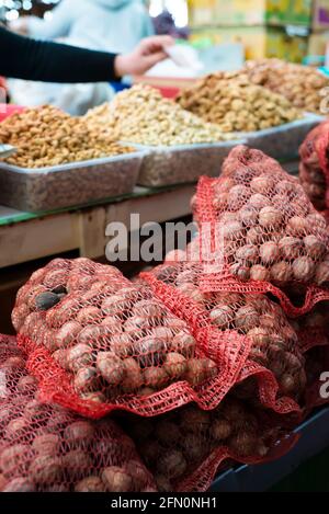 Walnut bags and shelled walnut counters. Grocery bazaar. Sale of vegetables and fruits and nuts. Stock Photo