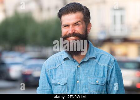 Smilling man outdoor. Male city portrait. Walking on town streets. Hipster outdoors. Stock Photo