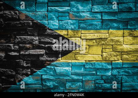 National flag of Bahamas on stone  wall background.The concept of national pride and symbol of the country. Flag  banner on  stone texture background. Stock Photo