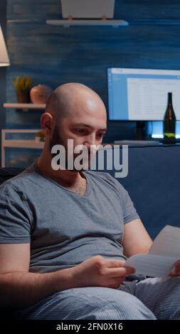 Desperate, depressed, helpless frustrated man reading paper letter with banking bills crying having notification, eviction notice. Shocked male by financial problems bankruptcy, unexpected bad news Stock Photo