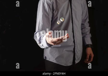 The man in the shirt throws the dice. Dice floating in the air. Stock Photo