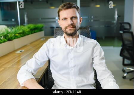 a portrait of a man in the office talking on a video link. Online conference Stock Photo