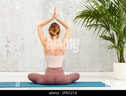 Old woman sitting in yoga meditation position in lotus pose with praying  hands Stock Vector | Adobe Stock