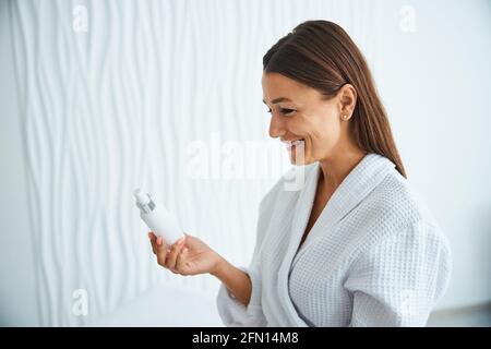 Contented beauty salon customer viewing a new cosmetic product Stock Photo