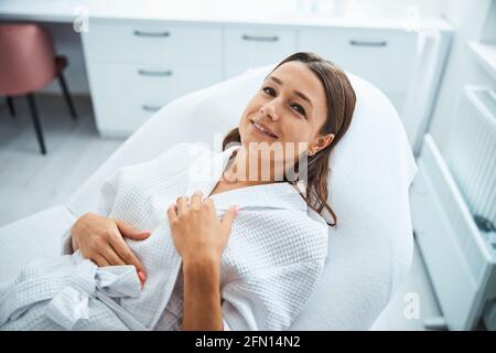 Smiling beauty salon customer relaxing before a cosmetic procedure Stock Photo