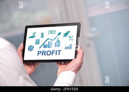 Profit concept shown on a tablet held by a man Stock Photo